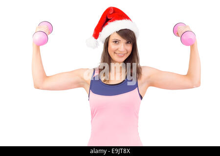 La donna a santa hat holding peso a mano Foto Stock