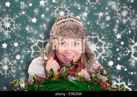 Immagine composita di felice bionda in abbigliamento invernale Foto Stock