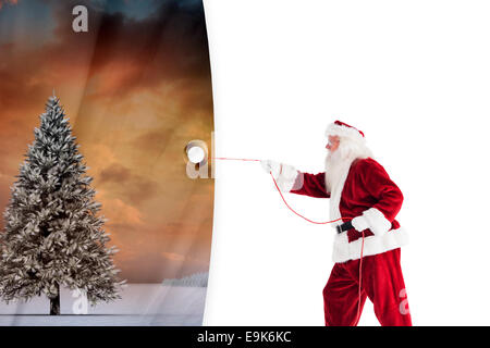 Immagine composita di santa tira qualcosa con una corda Foto Stock