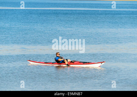 L'uomo galleggiante nella sua canoa sul fiume stour Essex REGNO UNITO Foto Stock