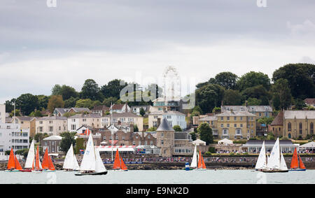 La I Maghinò (rosso) vele e la vittoria di classe yachts passare il Royal Yacht Squadron durante la Aberdeen Asset Management Cowes Week. E Foto Stock