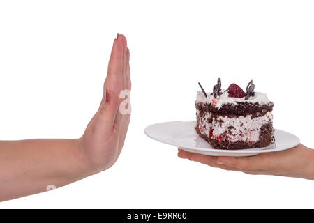 Donna mano gesti no alla torta piena di calorie, isolato su bianco Foto Stock