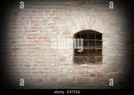 Dettaglio di una finestra medievale sulla fortezza esterno muro di mattoni Foto Stock
