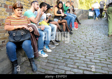 Londra, Inghilterra, Regno Unito. Camden Lock - persone sedute e mangiare fuori Foto Stock