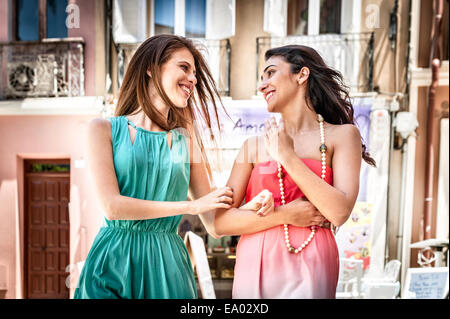 Due giovani alla moda donna Chiacchierando e passeggiando per strada, Cagliari, Sardegna, Italia Foto Stock