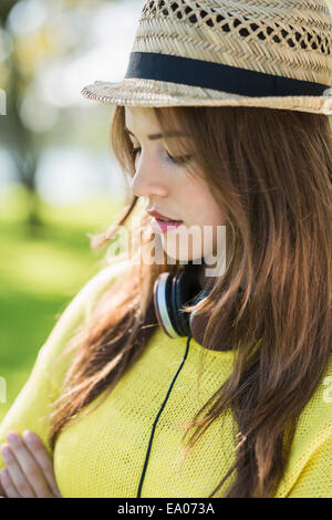 Giovane donna che indossa cappello di paglia, ritratto Foto Stock