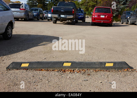 Tappo ruota blocco di parcheggio in una ruvida car park Saskatchewan Canada Foto Stock