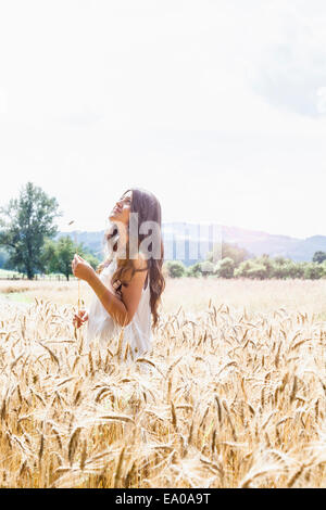 Giovane donna nel campo di grano Foto Stock