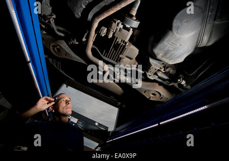 Hildesheim, Germania. 5 Novembre, 2014. Ispettore tecnico del TUV NORD, tecniche di ispezione, associazione Geert Dannhauer, esamina una Volkswagen Tiguan auto presso il TUV Nord il test e la stazione di servizio a Hildesheim, Germania, 5 novembre 2014. Foto: Juian Stratenschulte/dpa/Alamy Live News Foto Stock