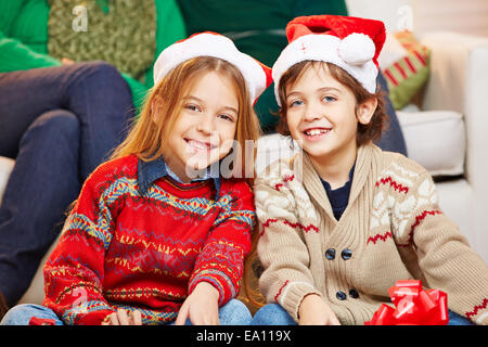 Due sorridenti bambini con cappelli di Natale Foto Stock