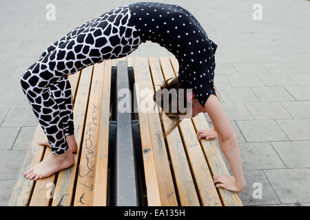 Ragazza adolescente facendo piegare indietro sul banco di lavoro Foto Stock