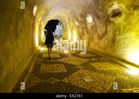 La donna nel tunnel in città vecchia Albufeira portando a Praia dos isole Pescadores beach, Algarve, Portogallo. Foto Stock