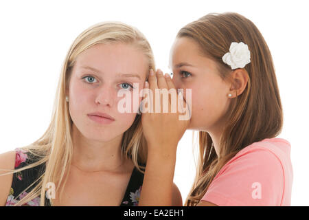 Le ragazze adolescenti sono whispering gossip a ciascun altro Foto Stock