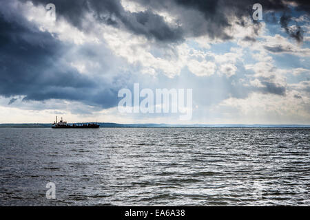 La pesca in barca sotto il sole di fronte cielo cloud Foto Stock