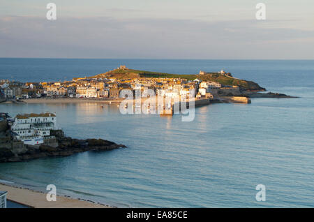 St Ives Harbour bathed in late afternoon sunlight viewed from clifftop above Porthminster Beach Penwith West Cornwall South West Foto Stock