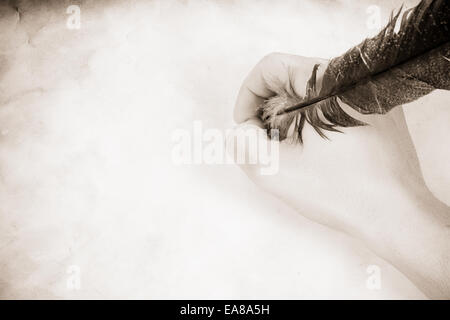 Immagine vintage maschile di mano che tiene la piuma Foto Stock