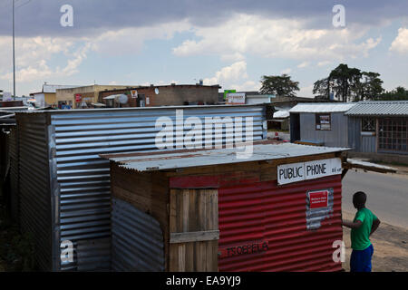 Il Lesotho. Il divario digitale. Telefono pubblico strutture nelle zone rurali del Lesotho situato in un ferro corrugato shack sulla strada principale. Foto Stock