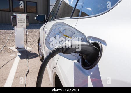 Le automobili elettriche di essere ricaricato a Ivanpah Solar Thermal Power Plant in California''s Deserto Mojave è attualmente il più grande impianto solare termico nel mondo. Esso genera 392 megawatt (MW) e distribuisce 173,500 heliostats che riflettono i raggi suns su tre torri solare. Esso copre 4.000 acri di deserto. Foto Stock