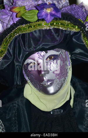 Donna con viola maschera e costume nero, il Carnevale di Venezia Foto Stock