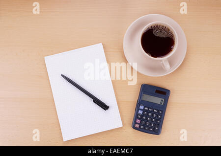 Appunti con penna, calcolatrice e la tazza di caffè sul desl Foto Stock