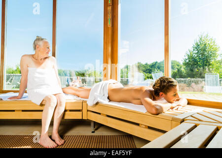Senior e giovane donna in sauna sudare in calore Foto Stock