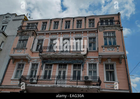 Vecchia casa con facciata interessante.ornamento metallico recinzione di balcone e gesso figura della parete. Deve essere ristrutturare. Foto Stock