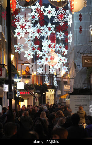 Londra, UK 16 Novembre 2014. Le luci di Natale su Carnaby Street visto da Regents Street come migliaia di londinesi e turisti si riunivano per la luce di natale fino cerimonia. Foto: David Mbiyu/ Alamy Live News Foto Stock