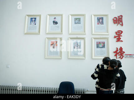 (141117) -- YINCHUAN, nov. 17, 2014 (Xinhua) -- Fotografia scattata a ott. 29, 2014 mostra le ragazze guardando una parete d'onore di Ningxia Arts School, a Yinchuan, capitale del nord-ovest della Cina di Ningxia Hui Regione autonoma. Le ragazze che sono stati addestrati in ballo tradizionale per un periodo di cinque anni, stanno facendo ogni sforzo per la imminente la graduazione delle prestazioni. Il corso di questa danza tradizionale, che è anche il solo a livello nazionale, è stato avviato da Ningxia Arts School oltre tre decenni fa. Come presto come negli anni cinquanta, una generazione più anziana di Hui ballerini in Ningxia aveva iniziato a creare un nuovo sistema di Hu Foto Stock