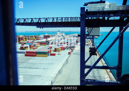 Gru e container a waterfront Foto Stock