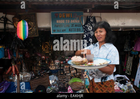 Donna Balinese con offerta in un negozio di Kuta. Bali. Indonesia. Saraswati giorno è uno stile Balinese tradizionale festa per celebrare th Foto Stock