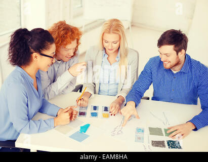 smiling creative team looking at sketch Foto Stock