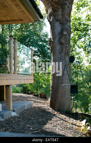 Scultura Moderna in giardino di legno e bungalow in boschiva, Midlothian, Scotland, Regno Unito Foto Stock