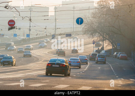 Sun a Mosca, in Russia. Giovedì 9 Novembre 20, 2014. Meteo: Sun, lo smog e il gelo a Mosca, in Russia. La temperatura è piuttosto freddo, fino a -11°C (12,2°F). O nuvoloso o soleggiato, nessuna neve a tutti e praticamente nessun vento. Così le regole di smog il giorno e trasporti aggiunge i suoi gas di scarico per l'aria di città al di sopra di tutto il resto. Il traffico sulla grande ponte Ustinsky. Credito: Alex Immagini/Alamy Live News Foto Stock