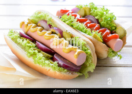 Classic hot dog con senape e ketchup su sfondo di legno,fuoco selettivo Foto Stock