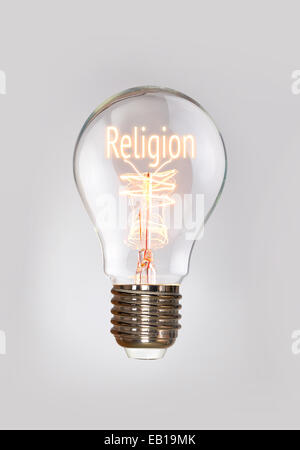 La religione e la fede in un concetto di lampadine a filamento. Foto Stock