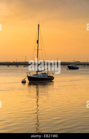 Tramonto sul fiume Deben con ormeggiate barche a vela al traghetto Bawdsey Suffolk Foto Stock