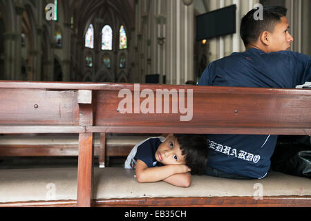 Due ragazzi seduti in banchi a Guayaquil la Cattedrale Metropolitana. Foto Stock