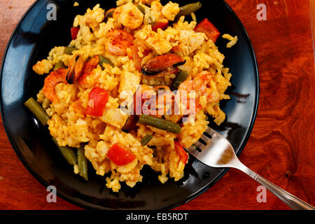 La paella sulla piastra nera Foto Stock