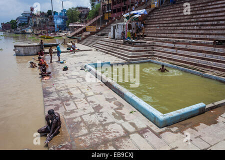 Pellegrini indù prendere un bagno santo da parte del fiume Gange a Varanasi o Benares Foto Stock