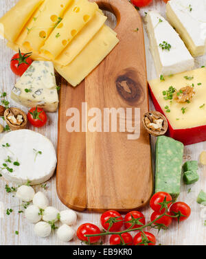 Vari tipi di formaggio con dadi e pomodori. Messa a fuoco selettiva Foto Stock