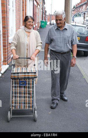 Coppia di anziani sul loro modo di negozi, Foto Stock