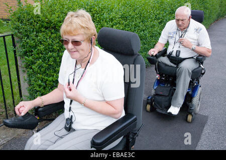 Disabilitato giovane fuori in strada utilizzando i telefoni cellulari per comunicare gli uni con gli altri Foto Stock