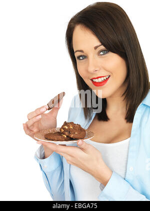 Attraente venti qualcosa di donna di mangiare i biscotti Foto Stock