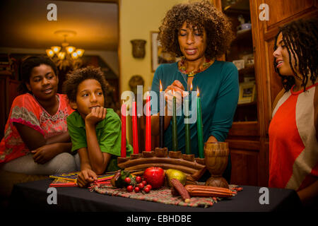 Famiglia kinara illuminazione candele, celebra Kwanzaa Foto Stock