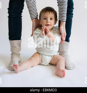 Ritratto di simpatici baby girl (12-17 mesi) con la sua mamma Foto Stock