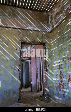 Giochi di luce in una casa presa da dune e deserto di sabbia, edificio del vecchio villaggio Kolmanskop in corrispondenza di una miniera di diamanti, Namibia, Kolmanskop Foto Stock