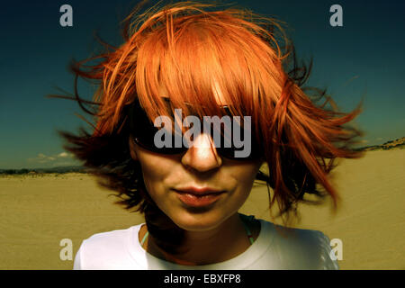 Ritratto di una donna redhaired con occhiali da sole Foto Stock