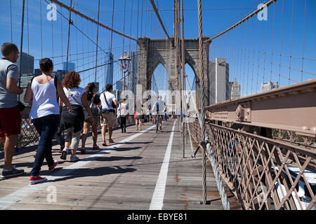 La gente a piedi attraverso il Ponte di Brooklyn a New York City, Stati Uniti d'America. Foto Stock