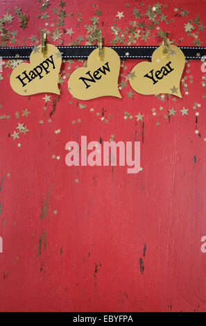 Felice Anno Nuovo sfondo con appesa con un testo di esempio su rosso rustico invecchiato in legno vintage. Verticale. Foto Stock