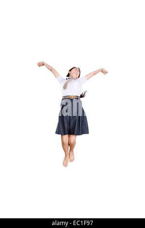 1 Indian School girl studente Jumping Fun Foto Stock